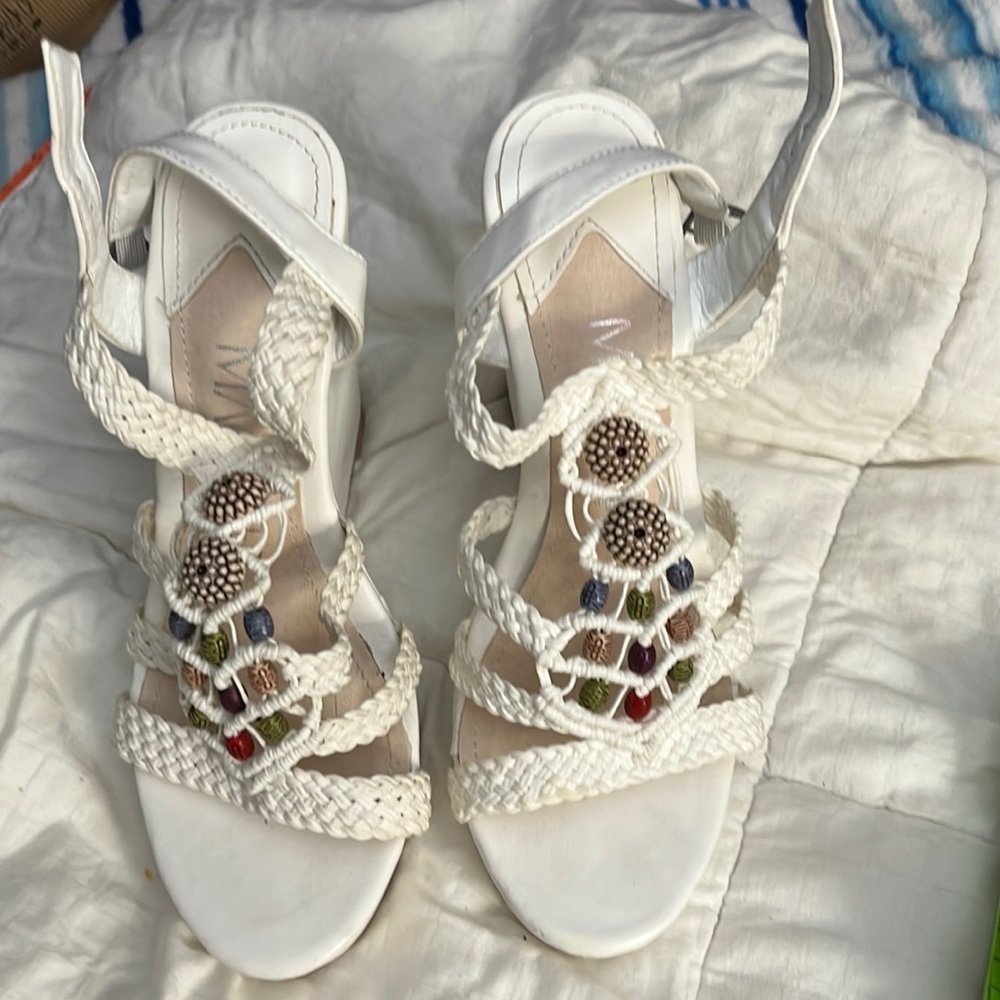 A white wedge ankle platform by Mackinac with beading and braided straps.